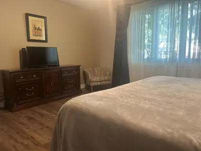 a bedroom with a bed and a flat screen tv at Cozy Home Away From Home in Kitchener