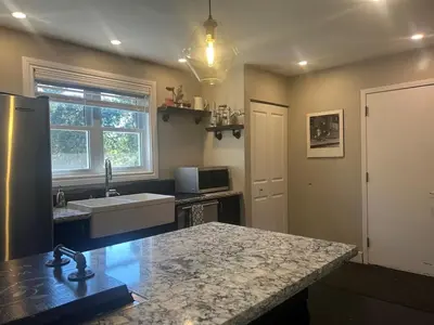 a kitchen with a sink and a counter top at Cozy Home Away From Home in Kitchener