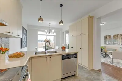 a kitchen with white cabinets and a sink at Tranquil Haven near Niagara in Thorold