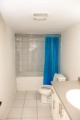 a bathroom with a toilet and a tub and a sink at Tranquil Haven near Niagara in Thorold