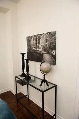 a table with two vases and a painting on a wall at Tranquil Haven near Niagara in Thorold