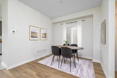 a dining room with a table and chairs at Stylish and Cozy Muskoka Vacation Home in Gravenhurst