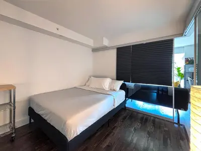 a bed with an aquarium in a room at DT Cozy 1B1B with Den near UofT and Bay St in Toronto