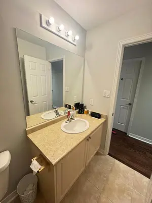 a bathroom with a sink and a large mirror at Gorgeous Private room in Toronto