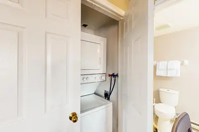 a white bathroom with a washer and dryer at Condo 701 at North Creek Resort in Blue Mountains