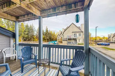a porch with chairs and a table and a view of a street at Condo 701 at North Creek Resort in Blue Mountains