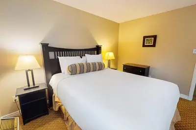 a bedroom with a large white bed and two lamps at Condo 701 at North Creek Resort in Blue Mountains