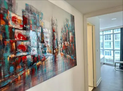 a painting hanging on a wall in a room at Spacious two-bedroom abode in the heart of TO in Toronto