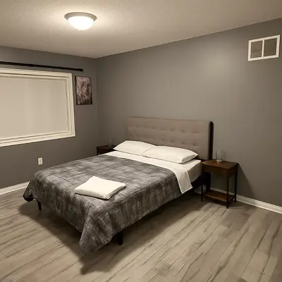 a bedroom with a bed with two pillows on it at Spacious Brampton 4BR Upper Home in Brampton