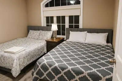 a bedroom with two beds and a window at Spacious Brampton 4BR Upper Home in Brampton