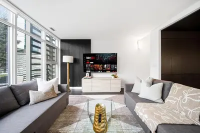 a living room with a couch and a tv at Luxury 4BR Home Sleeps 14 with Parking in Toronto