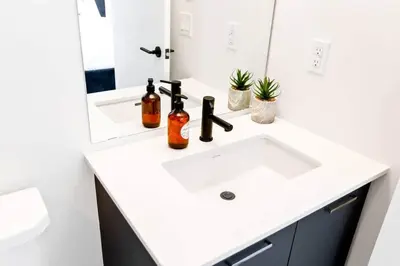 a bathroom with a white sink and a mirror at Spacious 3-BDR Home with Incredible View with parking in Toronto