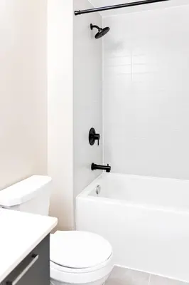 a white bathroom with a toilet and a shower at Spacious 3-BDR Home with Incredible View with parking in Toronto