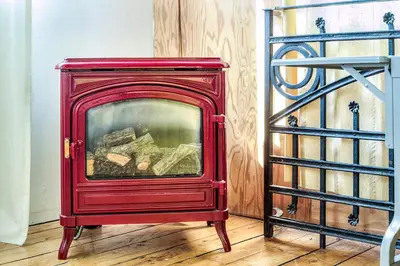 a red fireplace sitting on top of a wooden floor at Unique Above Garage Loft in Toronto