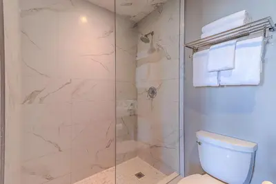 a bathroom with a shower and a toilet at Dream Suites Near YYZ Airport in Mississauga