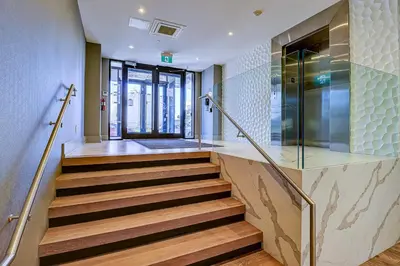 a staircase in a building with a glass wall at Dream Suites Near YYZ Airport in Mississauga
