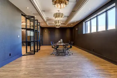 a conference room with a table and chairs at Dream Suites Near YYZ Airport in Mississauga