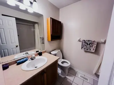 a bathroom with a sink and a toilet at Family Comfort Retreat in Brampton