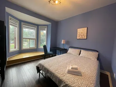 a blue bedroom with a bed and a window at Quiet King Bedroom near DT Toronto in Toronto