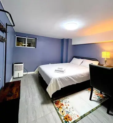 a bedroom with a bed and a blue wall at Quiet King Bedroom near DT Toronto in Toronto