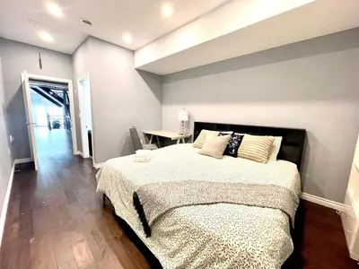 a bedroom with a large bed and a table at Quiet King Bedroom near DT Toronto in Toronto