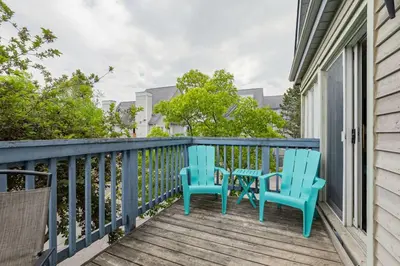two chairs and a table on a balcony at 109 North Creek in Blue Mountains