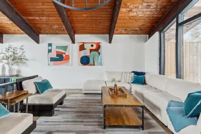 a living room with a couch and a table at 8 Bedroom Blue Mountain Chalet with Ping-Pong - 218 Arlberg in Blue Mountains
