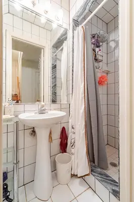 a white bathroom with a sink and a shower at Studio Apartment in Casa, semi-bsmt in Toronto