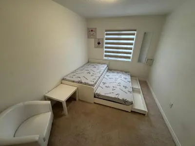 a small room with a bed and a window at Fully furnished 3BR, 3WR entire two storey with unfinished basement- Ford Milton , ON Canada in Milton
