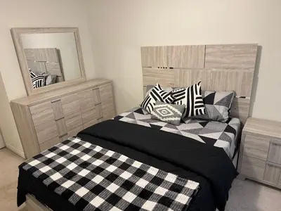 a bedroom with two beds and a mirror at Fully furnished 3BR, 3WR entire two storey with unfinished basement- Ford Milton , ON Canada in Milton