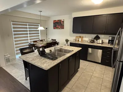 a kitchen with a sink and a counter top at Fully furnished 3BR, 3WR entire two storey with unfinished basement- Ford Milton , ON Canada in Milton