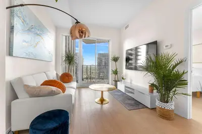 a living room with a white couch and a table at Hidden gem in Humber bay shores Toronto with parking in Toronto