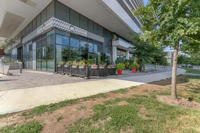 a building with potted plants in front of it at Hidden gem in Humber bay shores Toronto with parking in Toronto