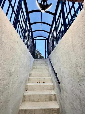 a staircase leading up to a building with a ceiling at Modern Cozy Basement Suite Free Parking in Brampton