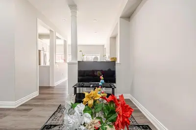 a living room with a christmas tree on the floor at Comfortable Brampton Getaway 3BR, 3BA, 4 Beds in Brampton