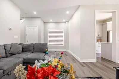 a living room with a couch and a table at Comfortable Brampton Getaway 3BR, 3BA, 4 Beds in Brampton
