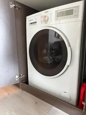 a white washing machine sitting in a room at Elegant and Charm Superior Suite Yorkville Toronto in Toronto