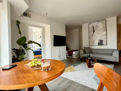 a living room with a table and a couch at Elegant and Charm Superior Suite Yorkville Toronto in Toronto