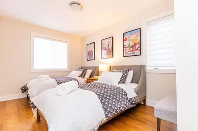 a bedroom with two beds and a couch at Relaxing Spa Getaway, Sauna, Hot Tub & Heated Pool in Blue Mountains