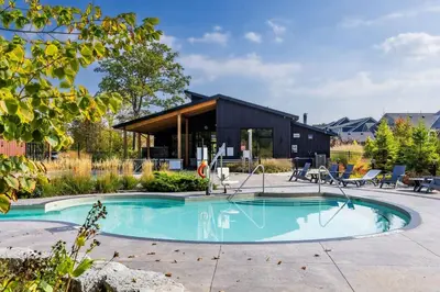 a house with a swimming pool in a yard at Relaxing Spa Getaway, Sauna, Hot Tub & Heated Pool in Blue Mountains