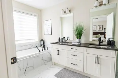 a white bathroom with a tub and a sink and a mirror at Relaxing Spa Getaway, Sauna, Hot Tub & Heated Pool in Blue Mountains