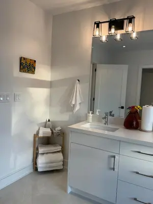 a bathroom with a sink and a mirror at Brand New Chic Townhouse in Toronto close to Yonge in Toronto