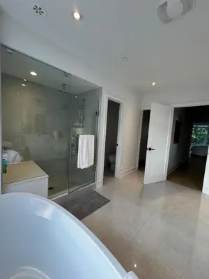 a bathroom with a tub and a glass shower at Brand New Chic Townhouse in Toronto close to Yonge in Toronto