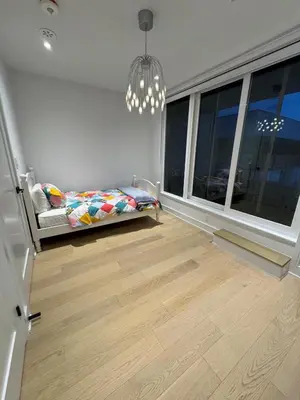 a bedroom with a bed and a large window at Brand New Chic Townhouse in Toronto close to Yonge in Toronto