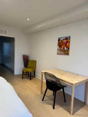a room with a wooden table and a chair at Brand New Chic Townhouse in Toronto close to Yonge in Toronto