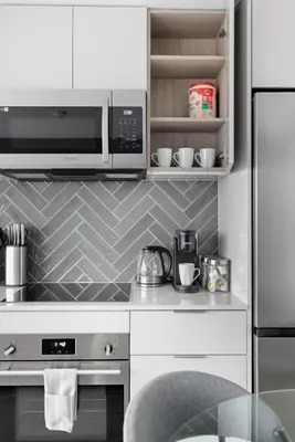 a kitchen with a microwave and a stove top oven at Stylish 2BR Retreat Parking & Sleeps 6 in Toronto