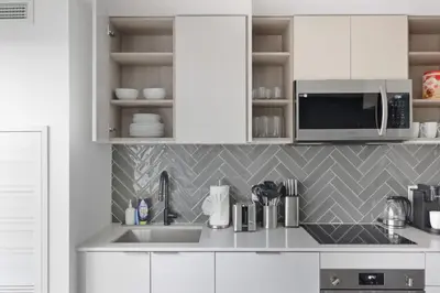 a kitchen with a sink and a microwave at Stylish 2BR Retreat Parking & Sleeps 6 in Toronto
