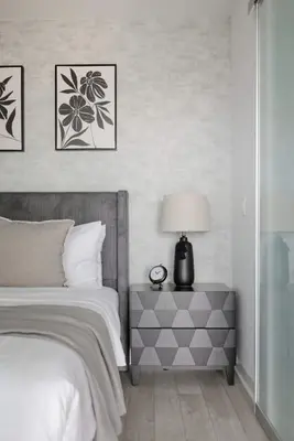 a bedroom with a bed and a table with a lamp at Stylish 2BR Retreat Parking & Sleeps 6 in Toronto