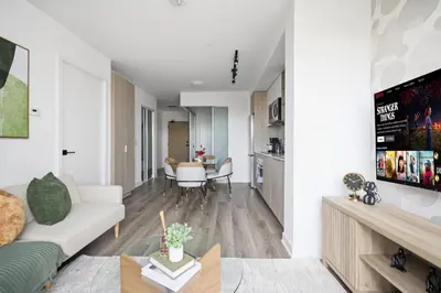 a living room with a couch and a table at Elegant 2BR Condo with 55 TV & City Views in Toronto
