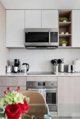 a kitchen with a microwave above a stove at Elegant 2BR Condo with 55 TV & City Views in Toronto